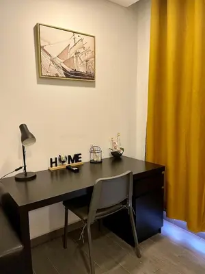 a desk with a lamp and a yellow curtain at Almada Downtown 104 in Porto