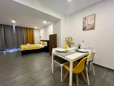 a living room with a table and chairs and a bed at Almada Downtown 104 in Porto