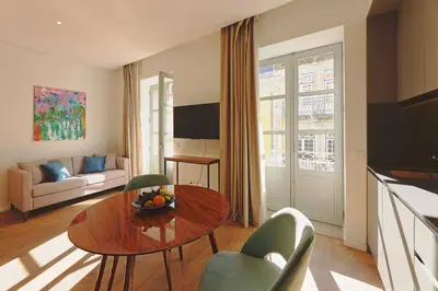 a living room with a table and chairs at RIBEIRA FLORES 59 Downtown Apartments in Porto