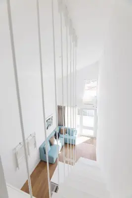 a living room with a blue chair and a mirror at RIBEIRA FLORES 59 Downtown Apartments in Porto