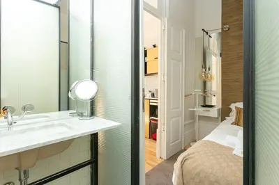 a bathroom with a sink and a bed in a room at Soprano Loft Porto Center - by Guest SPA in Porto