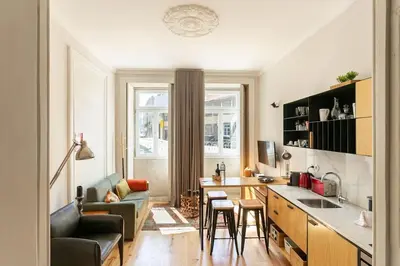 a kitchen and living room with a couch and a table at Soprano Loft Porto Center - by Guest SPA in Porto