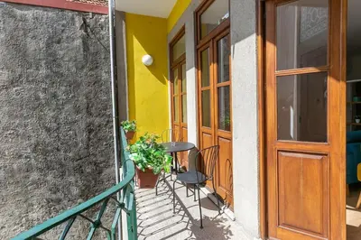 a balcony with a table and chairs next to a door at Valentino Loft Porto Center - by Guest SPA in Porto