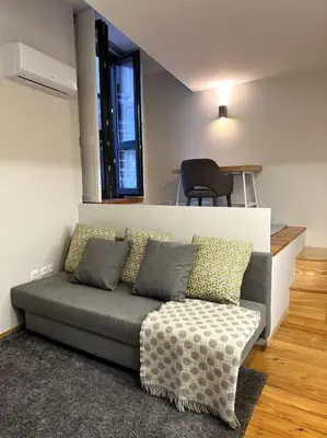 a living room with a couch and a table at Almada One in Porto