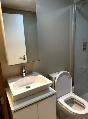 a bathroom with a toilet and a sink and a shower at Almada One in Porto