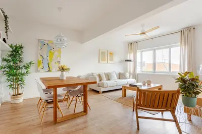 a living room with a table and chairs and a couch at Serpa Downtown Gaia in Vila Nova de Gaia
