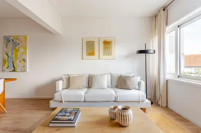 a living room with a white couch and a table at Serpa Downtown Gaia in Vila Nova de Gaia