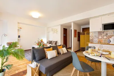 a living room with a couch and a table at Aposentus - Downtown Bright Apartment in Porto
