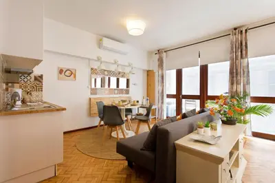 a living room with a couch and a table at Aposentus - Downtown Bright Apartment in Porto