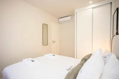 a bathroom with a toilet and a glass shower at Liiiving in Porto - Uptown Pearl Apartment in Porto