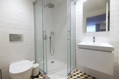a bathroom with a shower and a toilet and a sink at FLH Porto Downtown GuestHouse in Porto