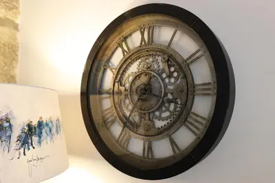 a clock hanging on a wall next to a book at FLH Porto Downtown GuestHouse in Porto