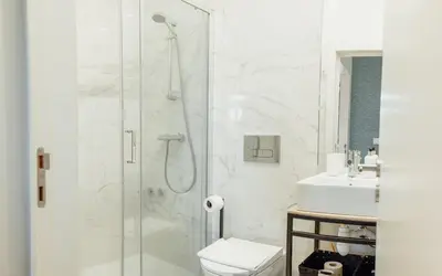 a white kitchen with a sink and a microwave at Oporto Pool Apartment by Vacationy in Porto
