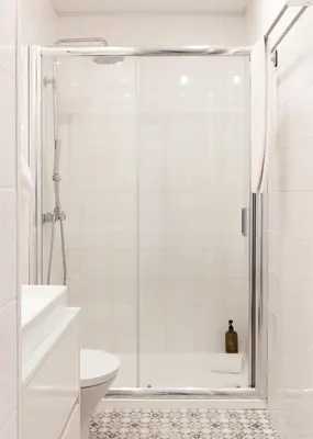a white bathroom with a shower and a toilet at VIVA Merchant's Way in Porto