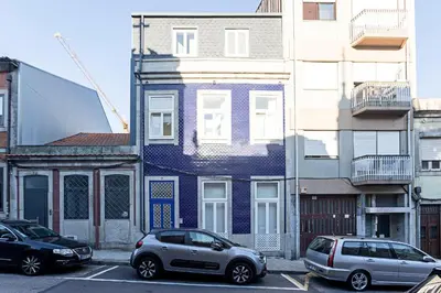 two cars parked in a parking lot in front of a building at Wonderful Duplex W Private Patio & AC by LovelyStay in Porto