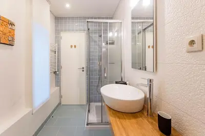 a bathroom with a white sink and a shower at GuestReady - Fantástico apt em Santa Catarina in Porto