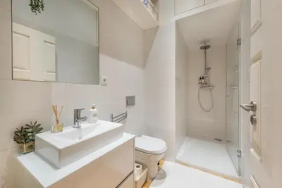a bathroom with a sink and a toilet and a shower at GuestReady - Rustic urban retreat in Porto
