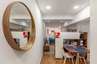 a dining room with a mirror and a table at Underground Batalha Studios in Porto