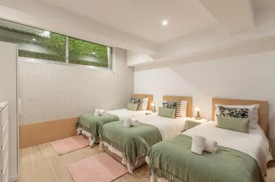 a bedroom with two beds and a window at Underground Batalha Studios in Porto