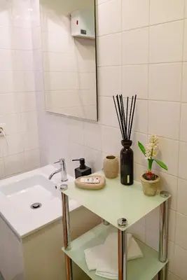 a white bathroom with a sink and a mirror at Bolhão Studio, Porto in Porto