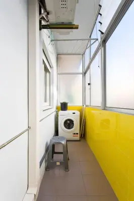 a bathroom with a washing machine and a chair in it at APOSENTUS - Serenity 1D in Porto