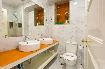 a white bathroom with a sink and a toilet at APOSENTUS - Serenity 1D in Porto