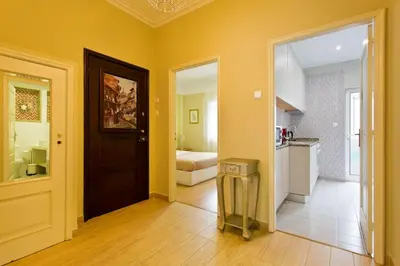 a room with a hallway with a door and a kitchen at APOSENTUS - Serenity 2D in Porto