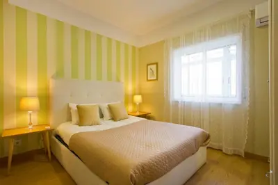 a bedroom with a large bed and a window at APOSENTUS - Serenity 2D in Porto