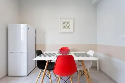a kitchen with a table and a refrigerator at APOSENTUS - Serenity 2D in Porto
