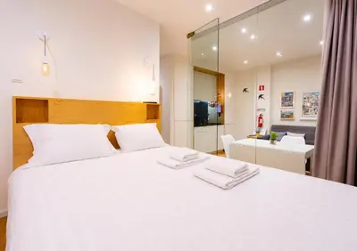 a white bathroom with a sink and a shower at Cozy apartment in the center of Porto in Porto