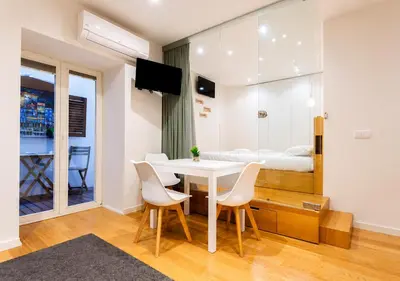 a bedroom with a large white bed with a mirror at Cozy apartment in the center of Porto in Porto