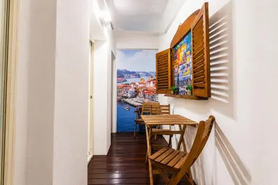 a hallway with tables and chairs and a view of the water at Cozy apartment in the center of Porto in Porto