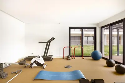 a room with a gym with exercise equipment on the floor at Dragão Rooftop in Porto