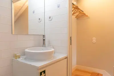a bathroom with a white sink and a mirror at DOISPONTOZERO Oliveirinhas in Porto