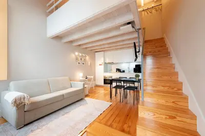 a living room with a couch and a table at DOISPONTOZERO Oliveirinhas in Porto