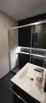 a bathroom with a white sink and a mirror at 504 New Apartment Galé in Porto
