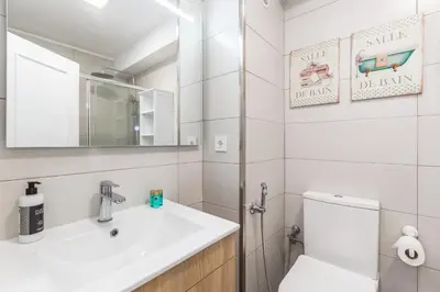 a bathroom with a sink and a toilet and a mirror at Hopstays - Oporto Musica in Porto