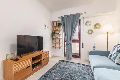 a living room with a tv and a couch at Hopstays - Oporto Musica in Porto