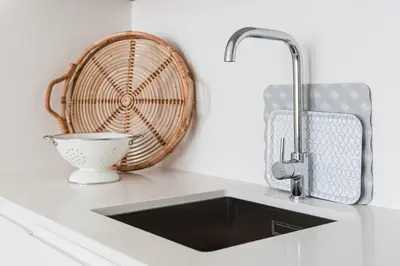 a kitchen counter with a sink and a basket at GuestReady - Bonjardim Building in Porto