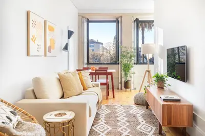 a living room with a couch and a table at República Garden View in Porto