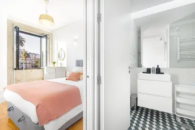 a bedroom with a bed and a bathroom at República Garden View in Porto