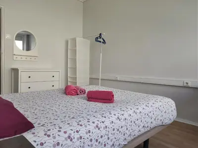 a bedroom with a bed with pink pillows on it at DISCOVER PORTO - Boavista 2 in Porto