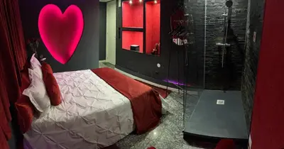 a bedroom with a heart sign on the wall at Modern & Central 3 minutes from the River in Vila Nova de Gaia