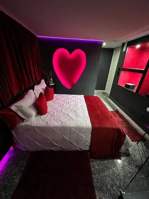 a bedroom with a heart sign on the wall at Modern & Central 3 minutes from the River in Vila Nova de Gaia
