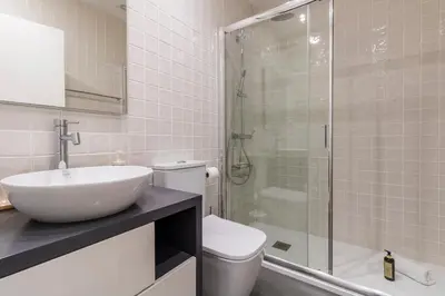 a bathroom with a toilet and a sink and a shower at WALAA Home@Almada Terrace by LovelyStay in Porto