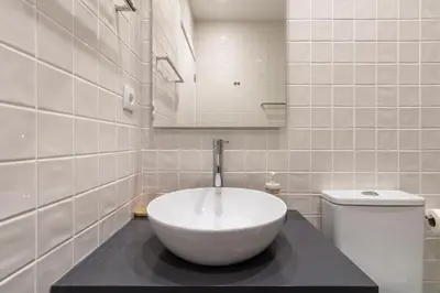 a white bathroom with a sink and a toilet at WALAA Home@Almada Terrace by LovelyStay in Porto