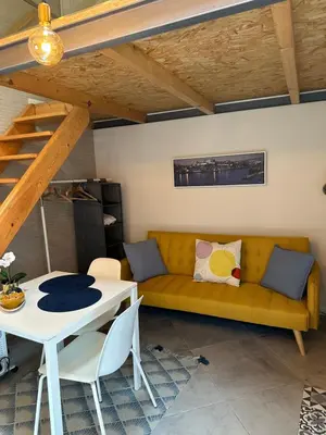 a living room with a yellow couch and a table at Ilhas Douro - Fontaínhas by PA Hotels in Porto