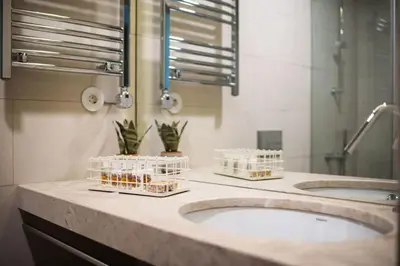 two sinks in a bathroom with two mirrors and plants at Estefânia Luxury Apartment Historic House Downtown in Porto