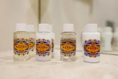 a group of four bottles of cleaner sitting on a counter at Estefânia Luxury Apartment Historic House Downtown in Porto
