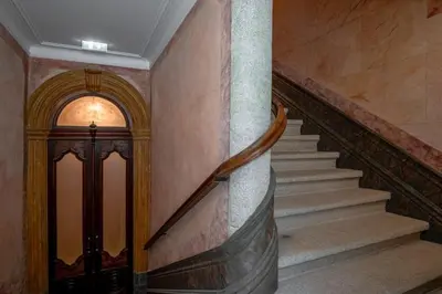 a spiral staircase in a building with a door and a stair case at Estefânia Luxury Apartment Historic House Downtown in Porto